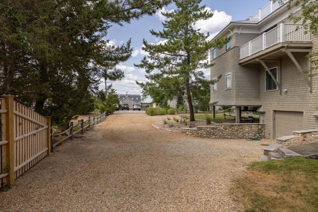 surrounding community featuring a garage, driveway, and fence