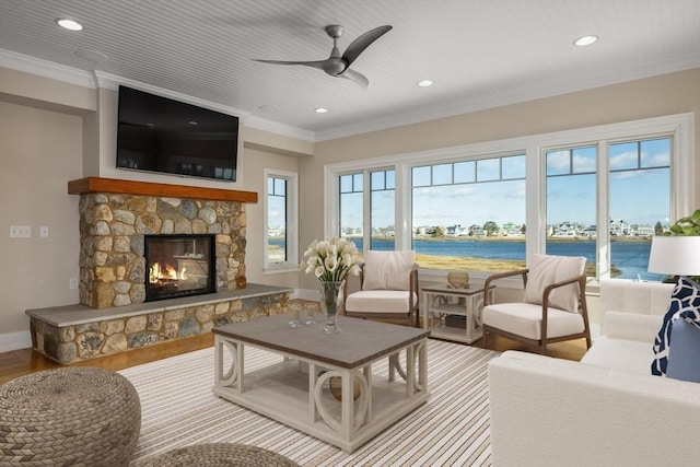 interior space featuring baseboards, ornamental molding, wood finished floors, a fireplace, and recessed lighting