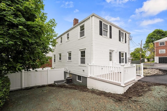 9 Bishop Rd, Quincy, MA 02170 - view of side of property with a chimney and a deck