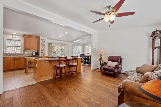 113 Glen Rd, Gorham, NH 03581 - living area featuring light wood-style flooring, baseboard heating, ceiling fan, recessed lighting, and a chandelier