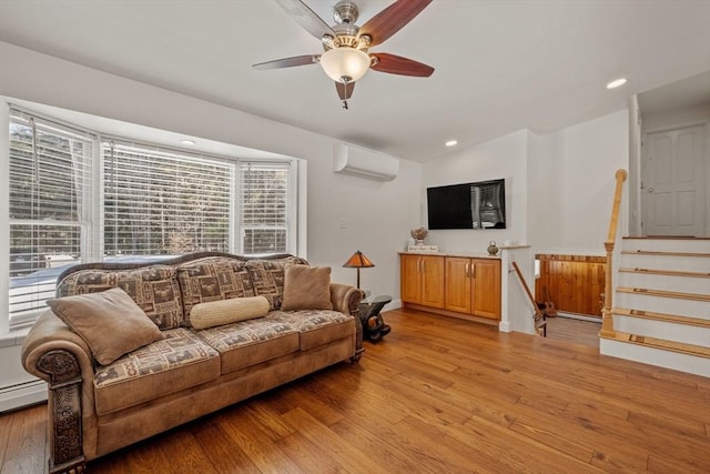 113 Glen Rd, Gorham, NH 03581 - living room with an AC wall unit, ceiling fan, light wood finished floors, recessed lighting, and stairway