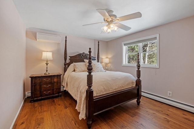 113 Glen Rd, Gorham, NH 03581 - bedroom featuring an AC wall unit, a baseboard radiator, wood finished floors, and ceiling fan
