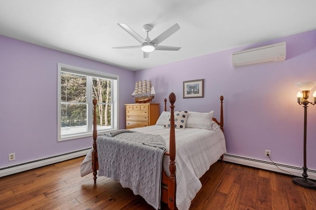 113 Glen Rd, Gorham, NH 03581 - bedroom featuring a wall mounted air conditioner, a baseboard heating unit, and wood finished floors