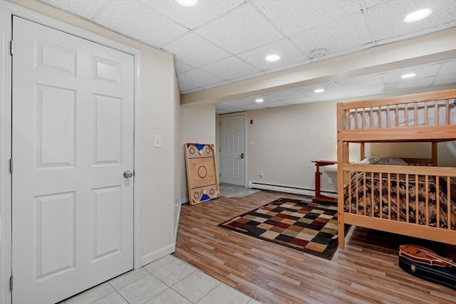 113 Glen Rd, Gorham, NH 03581 - bedroom featuring a baseboard radiator, a drop ceiling, light wood finished floors, baseboards, and recessed lighting