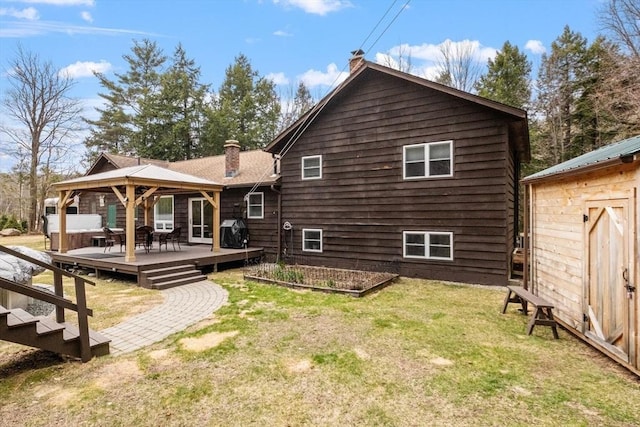 113 Glen Rd, Gorham, NH 03581 - back of house with a chimney, a gazebo, a lawn, a deck, and a vegetable garden