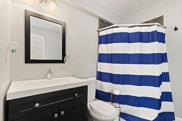 bathroom featuring toilet, vanity, and a shower with shower curtain