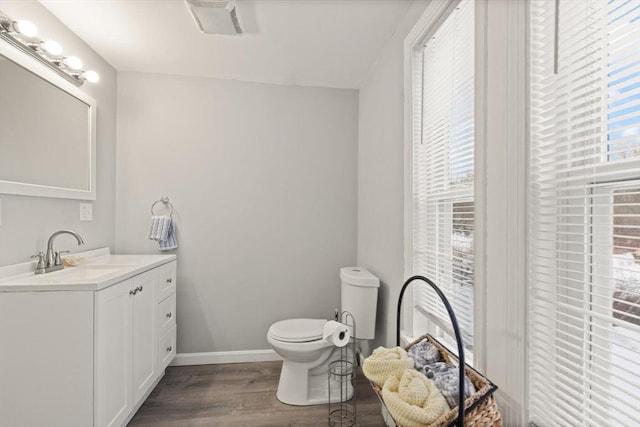 bathroom featuring hardwood / wood-style flooring, toilet, and vanity