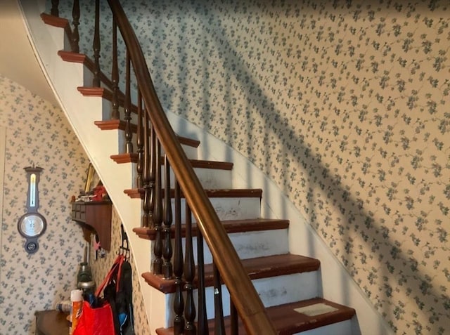 stairway with wallpapered walls