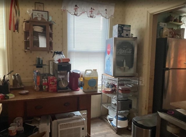 kitchen featuring freestanding refrigerator, wallpapered walls, and light wood-style flooring