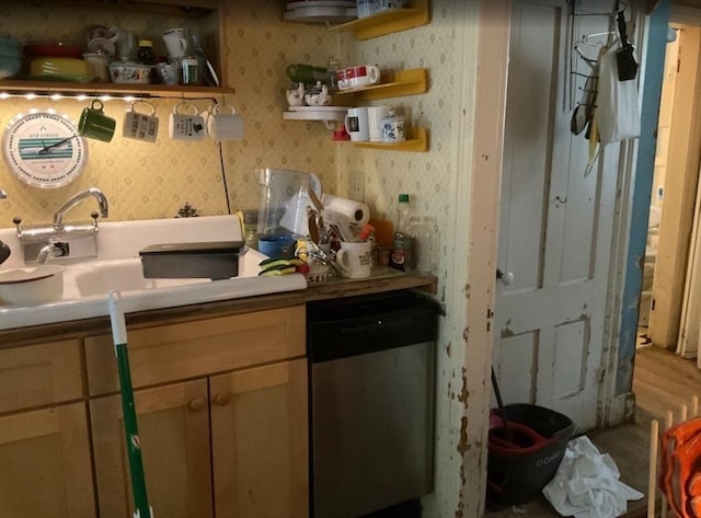 kitchen with dishwasher, wallpapered walls, open shelves, a sink, and light countertops
