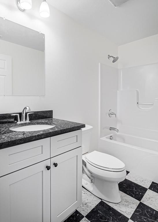 full bathroom with toilet, shower / bathing tub combination, and vanity