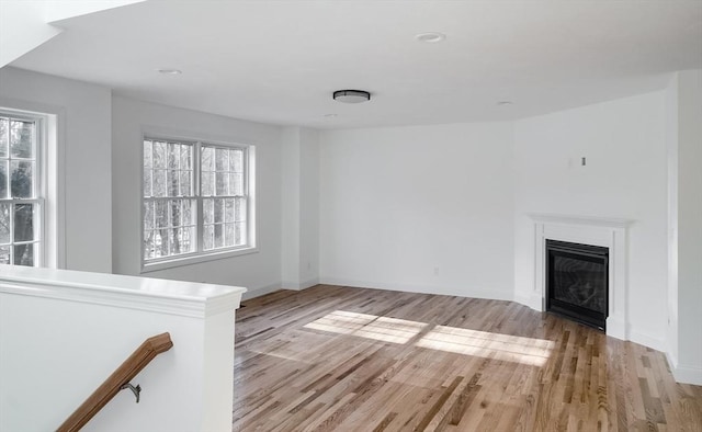 unfurnished living room with plenty of natural light and light hardwood / wood-style flooring