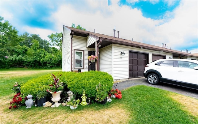 view of front facade with a garage and a front lawn