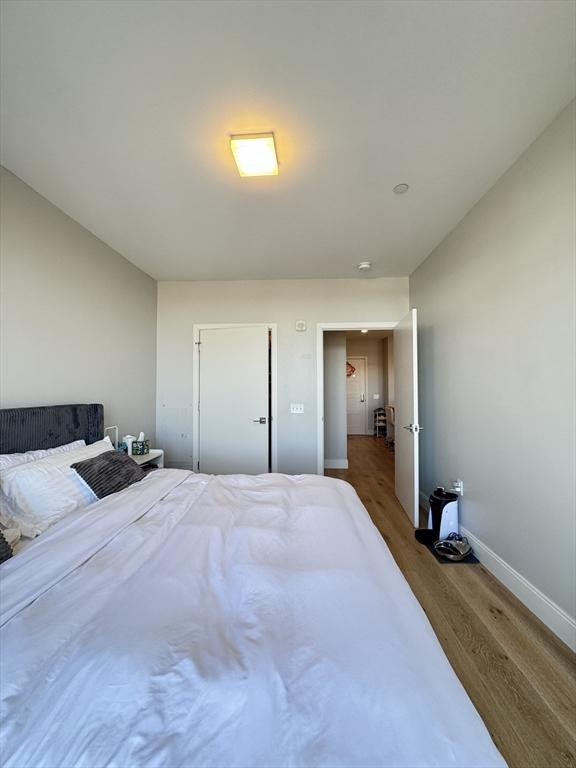 bedroom featuring baseboards and wood finished floors