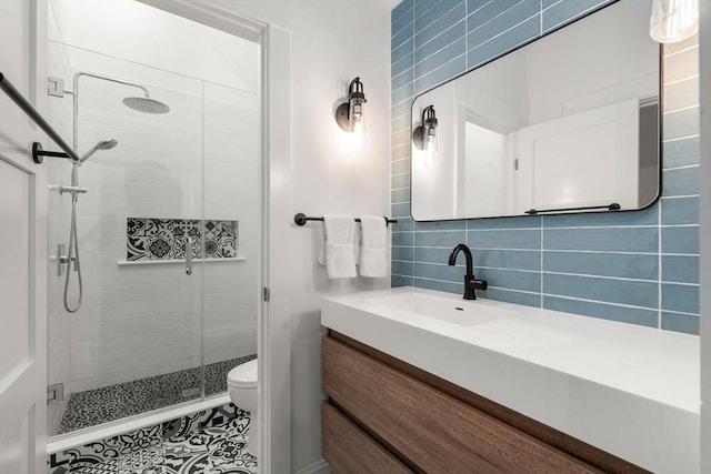 323 Lake Ave Unit 323, Newton, MA 02461 - bathroom with a stall shower, vanity, toilet, backsplash, and tile walls