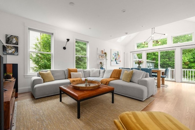 323 Lake Ave Unit 323, Newton, MA 02461 - living area featuring light wood-style floors, healthy amount of natural light, vaulted ceiling, and a skylight