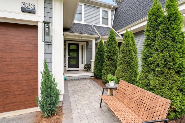 323 Lake Ave Unit 323, Newton, MA 02461 - view of exterior entry with a shingled roof and a garage