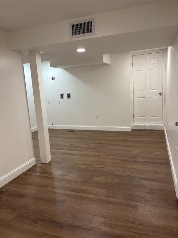 laundry area with dark hardwood / wood-style floors