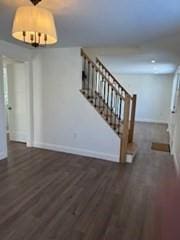 unfurnished living room with dark hardwood / wood-style flooring