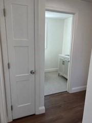 corridor featuring dark hardwood / wood-style flooring