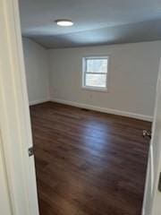 unfurnished room with dark hardwood / wood-style floors