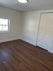 unfurnished room featuring dark hardwood / wood-style floors