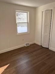 unfurnished bedroom featuring dark hardwood / wood-style flooring