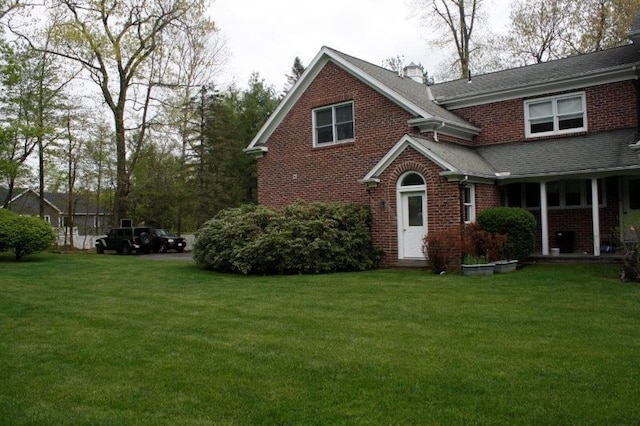 view of home's exterior with a yard