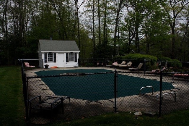 view of pool with an outdoor structure