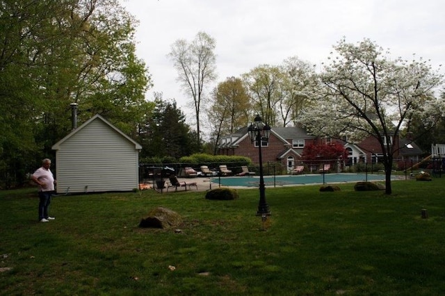 surrounding community featuring a pool and a lawn