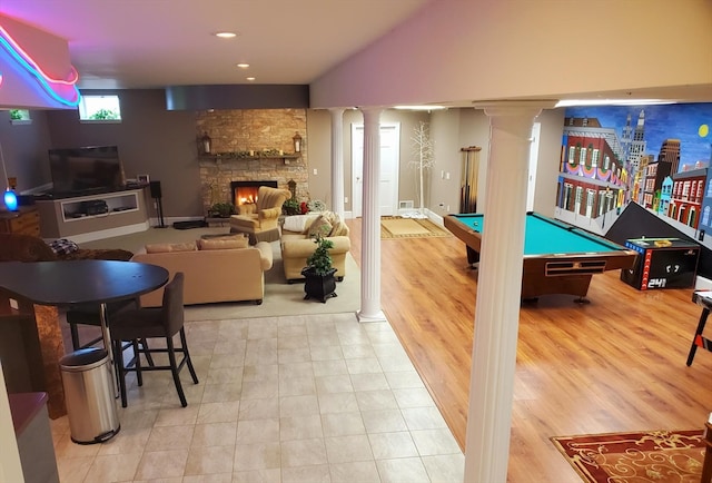 rec room featuring decorative columns, light tile flooring, a fireplace, billiards, and lofted ceiling