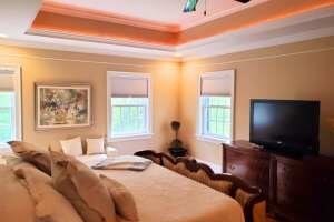 bedroom featuring a tray ceiling and crown molding