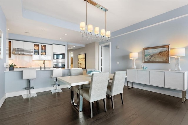 dining space featuring dark wood-type flooring and sink