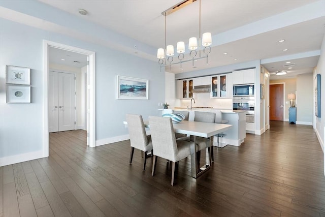 dining room with sink and dark wood-type flooring