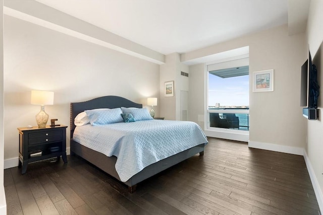 bedroom with dark wood-type flooring