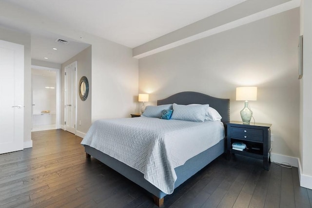 bedroom with dark hardwood / wood-style floors