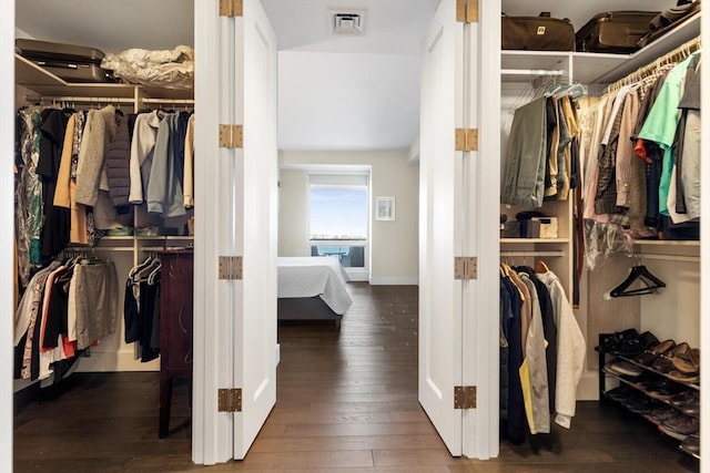 walk in closet featuring dark hardwood / wood-style floors