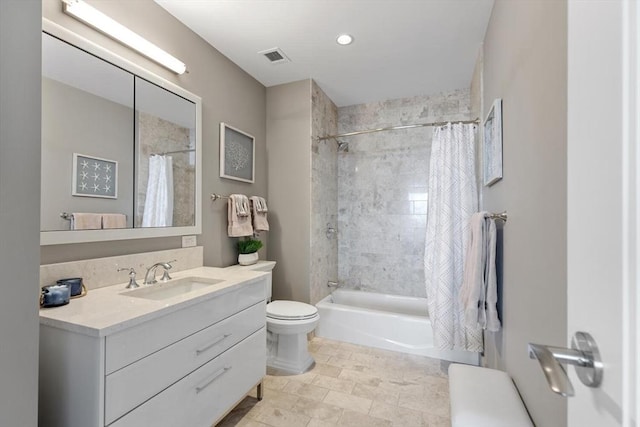 full bathroom with vanity, shower / tub combo, and toilet