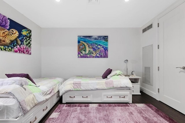 bedroom with dark hardwood / wood-style flooring