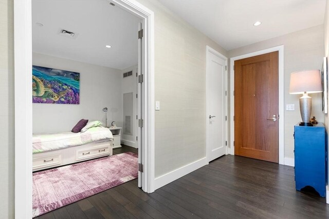 bedroom with dark hardwood / wood-style flooring