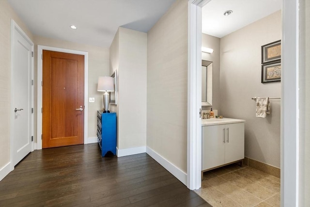 hallway featuring sink and dark hardwood / wood-style flooring