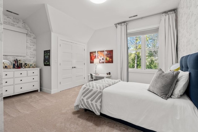 carpeted bedroom with visible vents, baseboards, and vaulted ceiling
