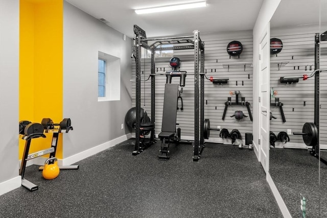 workout room with baseboards