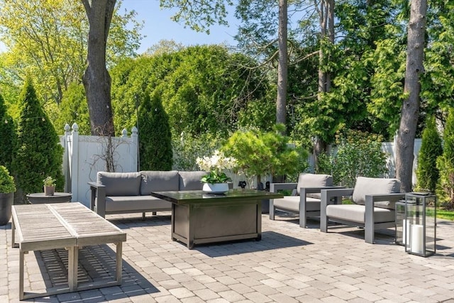 view of patio featuring outdoor lounge area and fence