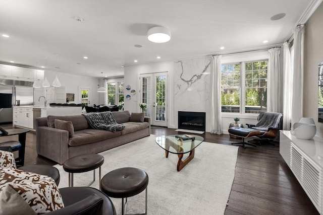 living area featuring recessed lighting, dark wood-style floors, and a healthy amount of sunlight