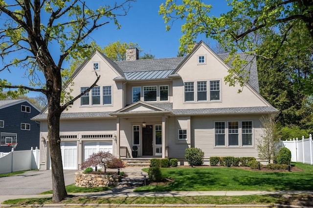 view of front of property featuring a garage, fence, a front yard, stucco siding, and a chimney