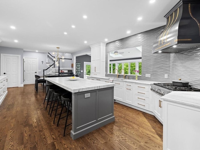 17 Olde Hickory Path, Westborough, MA 01581 - kitchen featuring wall chimney exhaust hood, stainless steel gas cooktop, a kitchen island, recessed lighting, and backsplash