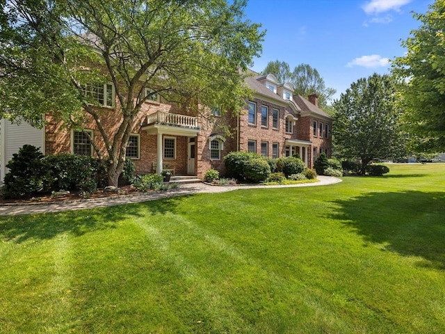 17 Olde Hickory Path, Westborough, MA 01581 - view of front of home with a front yard, brick siding, and a chimney