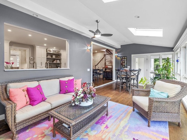 17 Olde Hickory Path, Westborough, MA 01581 - living room featuring wood finished floors, lofted ceiling, a skylight, a ceiling fan, and stairs