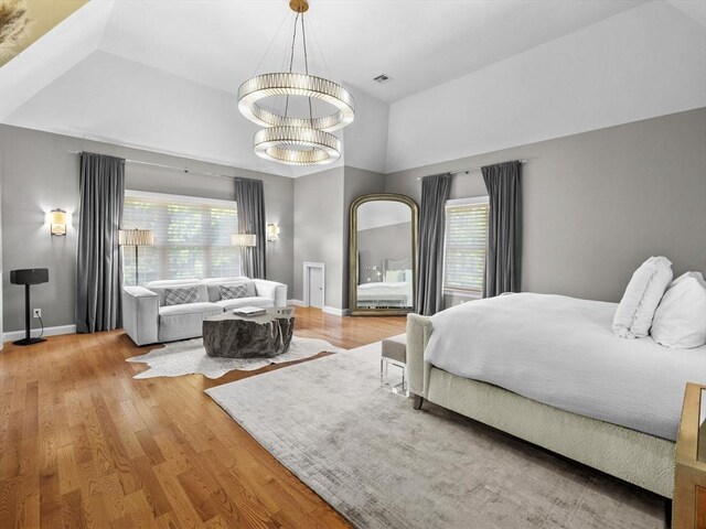 17 Olde Hickory Path, Westborough, MA 01581 - bedroom with multiple windows, wood finished floors, a chandelier, and a high ceiling
